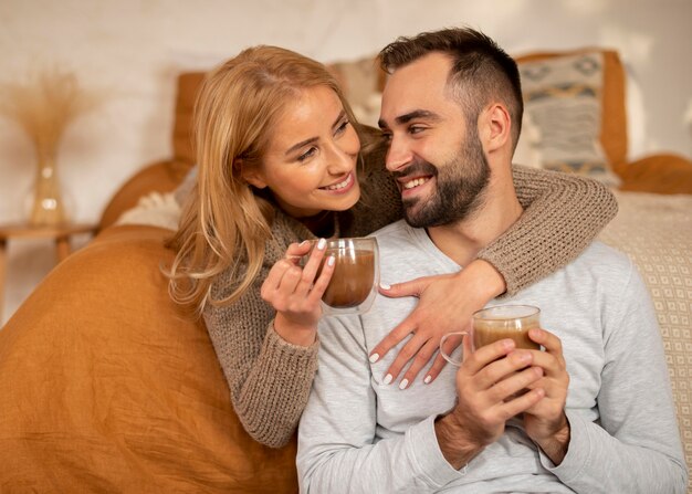 Happy couple with hot beverages