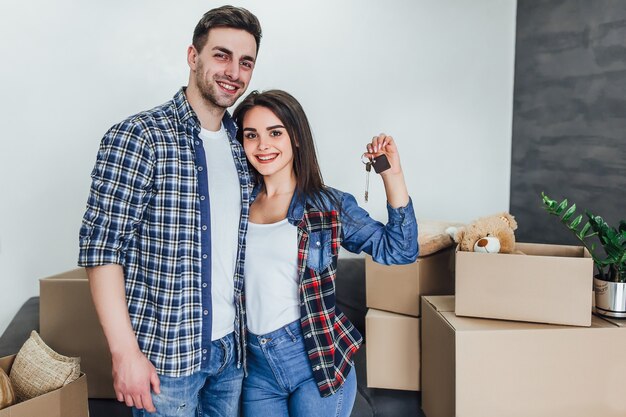 Happy couple with keys from new apartaments