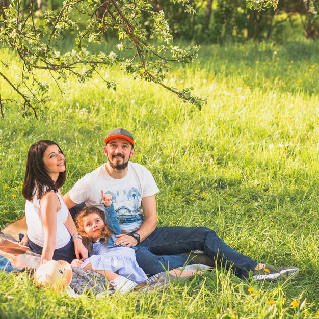 Happy couple with their daughter enjoying in the garden