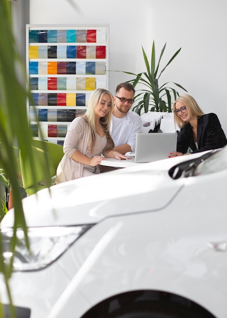 Happy customers in car dealership