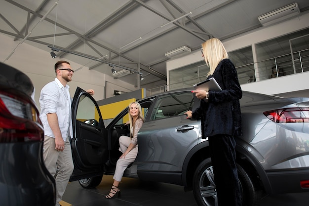 Happy customers in car dealership