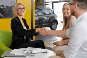 Free photo happy customers in car dealership