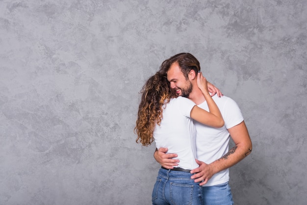 Happy cute couple in white hugging