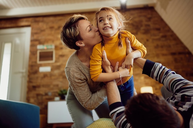 Happy daughter having fun while spending time with her parents at home