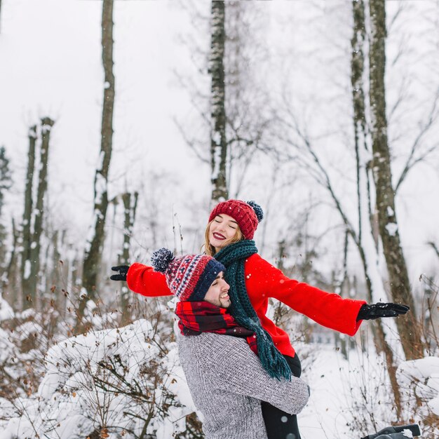 Happy dreaming couple in winter forest