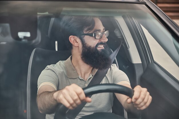 Happy driver with safety belt fastened