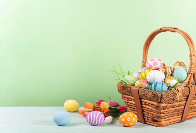 Free photo happy easter easter painted eggs in the basket on wooden rustic table for your decoration in holiday