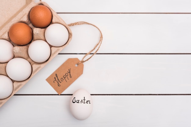 Happy Easter inscription with eggs in rack