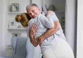 Free photo happy elderly couple hugging each other