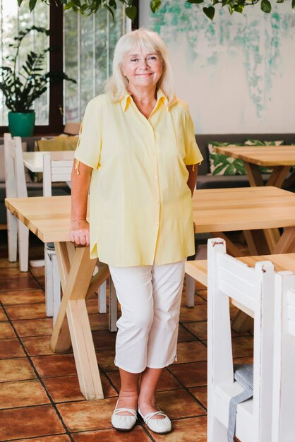 Happy elderly woman in cafe