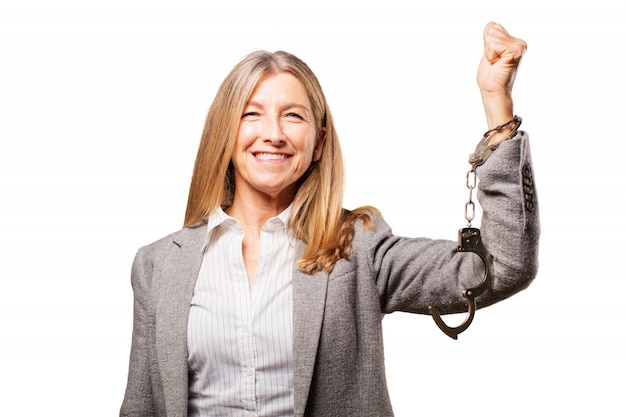 Happy elderly woman handcuffed