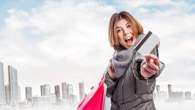 Happy employee with shopping bags and credit card