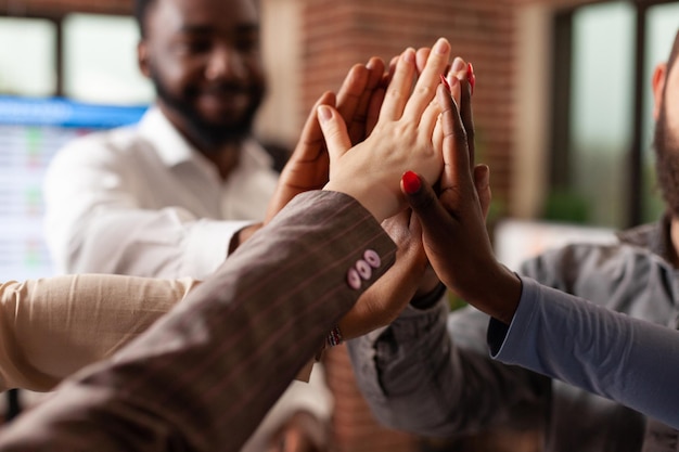 Free photo happy excited businessteam celebrating successful partnership enjoying together in startup office. diverse smiling businesspeople achievement business collaboration. concept of victory