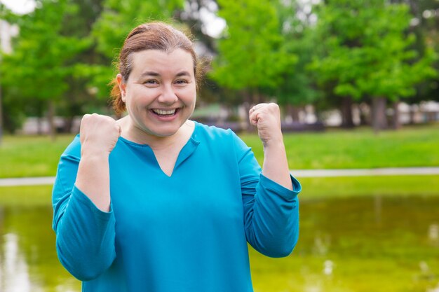 Happy excited plus sized woman celebrating success