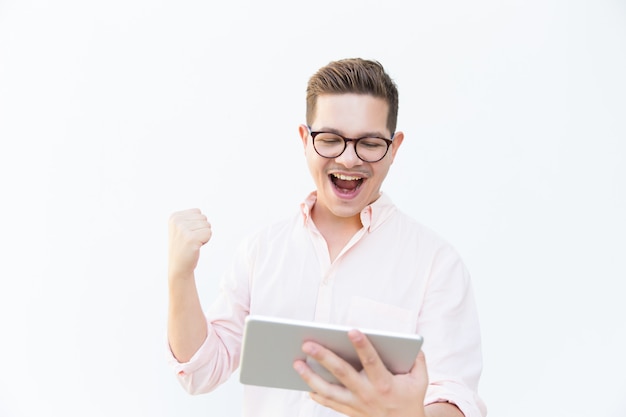 Happy excited tablet user shouting for joy