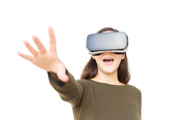 Happy excited woman in VR headset touching air and shouting