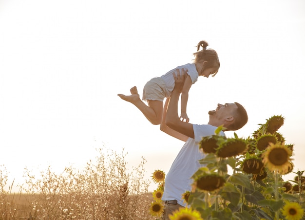 Happy family, father and daughter playing in the field