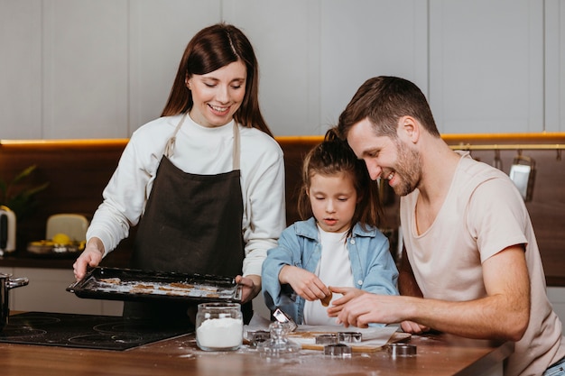 Happy family of father and mother with daughter cooking together