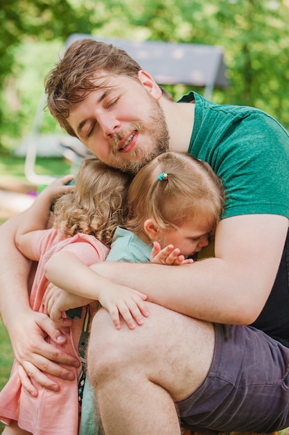 Free Photo happy family and father's day. child daughters hugging dad