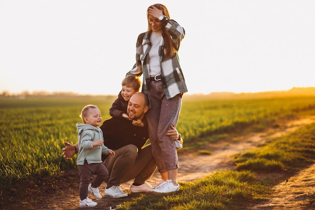 Happy family having fun in the field on the sunset