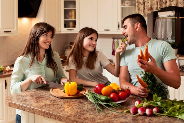 Free photo happy family in the kitchen preparing food