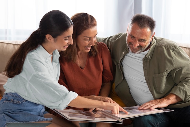 Happy family looking at picture album medium shot