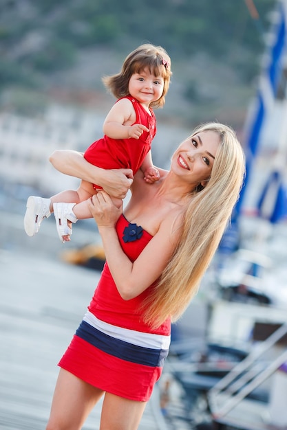 happy family of mother and cute baby outdoors