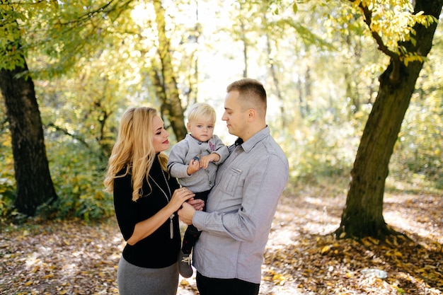 happy family playing and laughing in autumn park