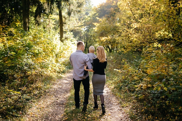 happy family playing and laughing in autumn park