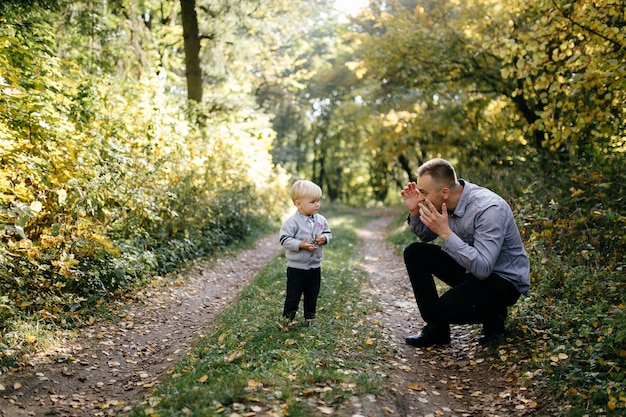 happy family playing and laughing in autumn park