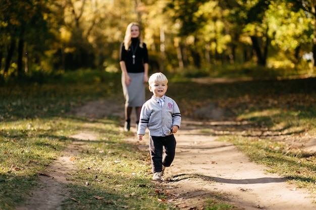 Free photo happy family playing and laughing in autumn park