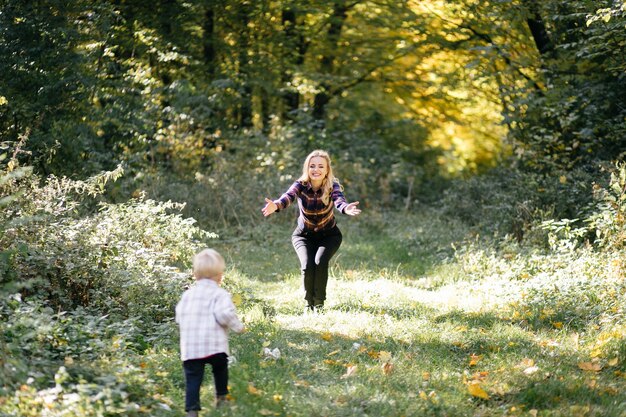 happy family playing and laughing in autumn park