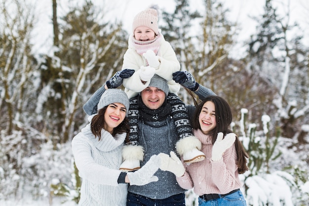 Happy family posing in winter forest