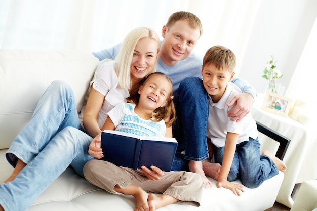 Free photo happy family reading a book