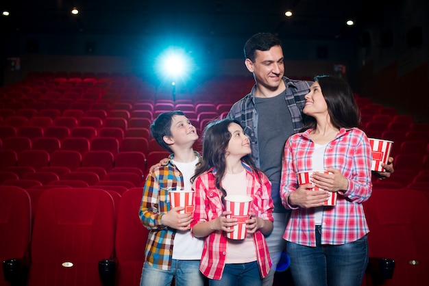 Happy family sitting in cinema