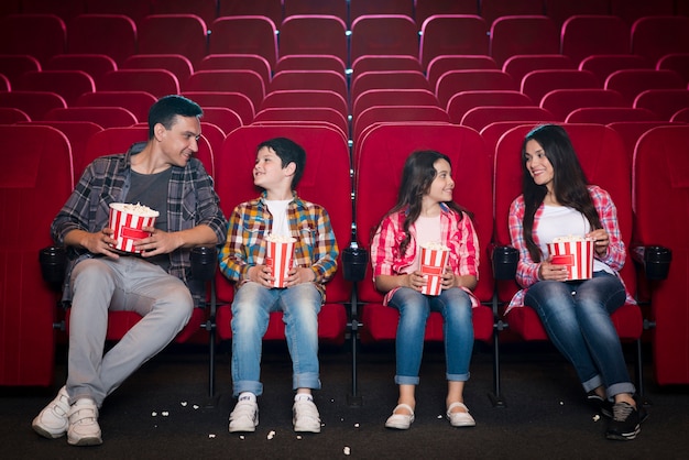 Happy family sitting in cinema