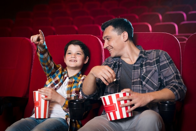 Happy family sitting in cinema