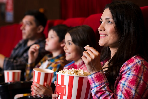 Happy family sitting in cinema