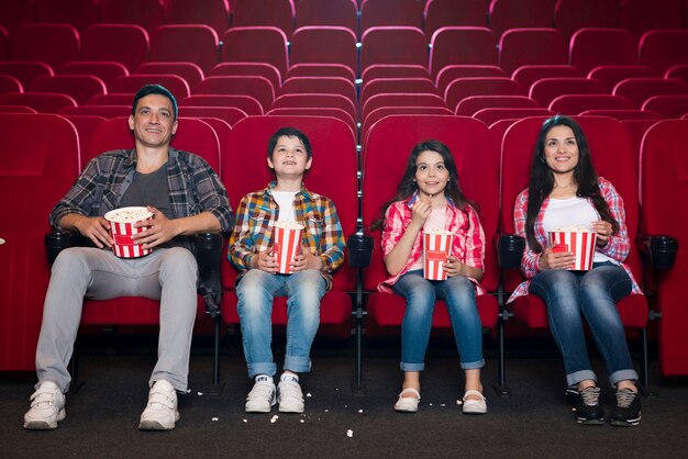 Happy family sitting in cinema