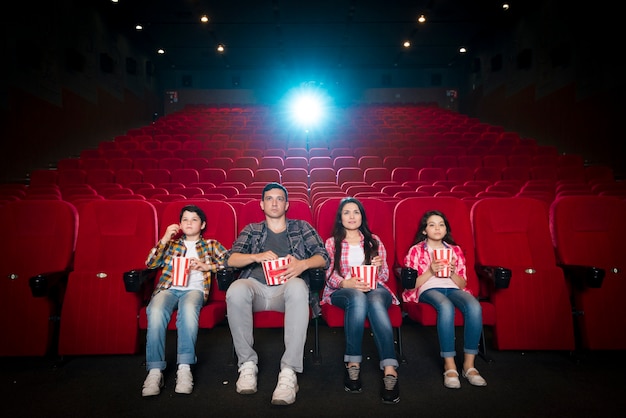 Free Photo happy family sitting in cinema