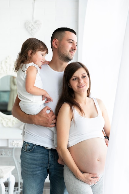 Happy family standing next to window