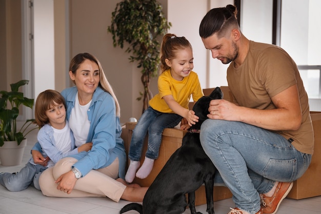 Happy family with dog moving in new home