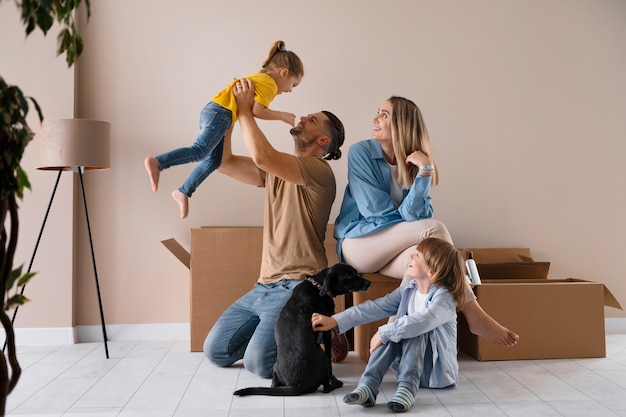 Happy family with dog moving in new home