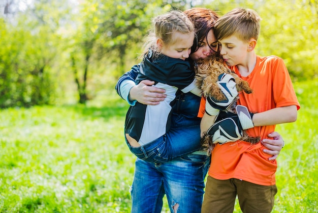 Free photo happy family with dog in the park