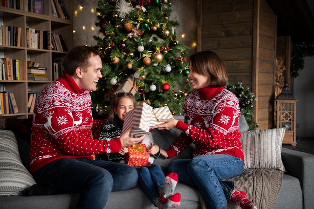 Happy family with presents medium shot