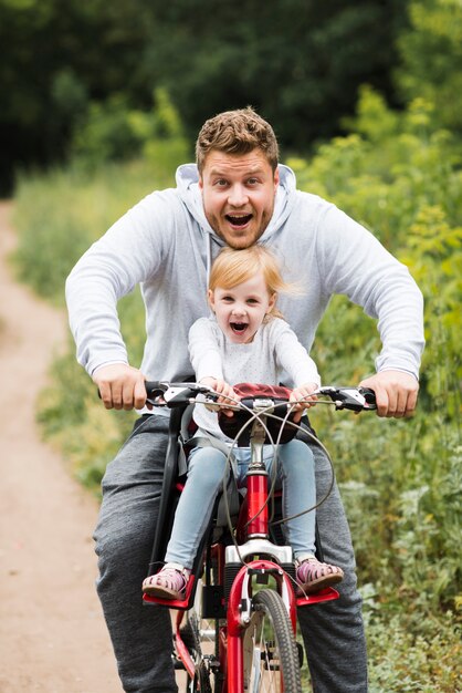 Happy father and daughter on bike