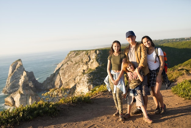 Free photo happy father hiking with children in mountains