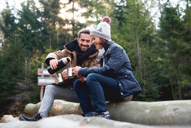 Free photo happy father and son drinking tea outdoors