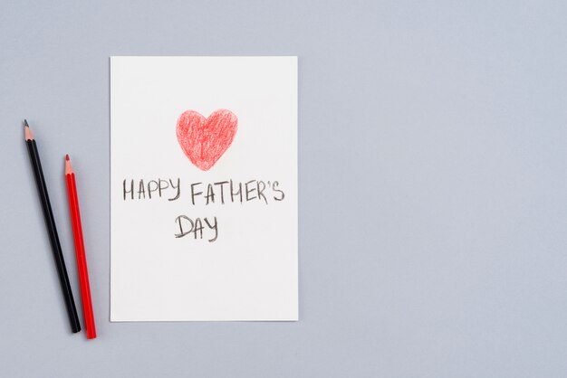 Happy Fathers Day inscription on paper with pencils