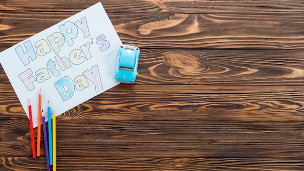 Free Photo happy fathers day inscription with toy car on table